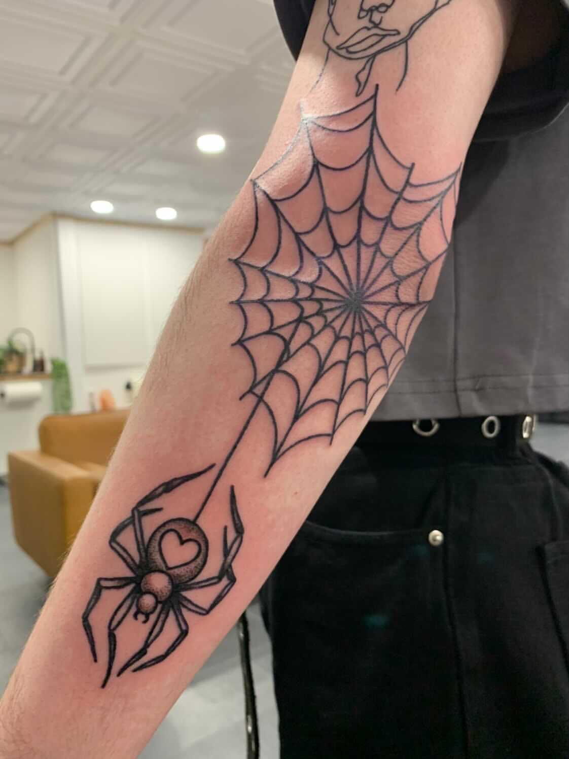 Spider Web Elbow Tattoo Meaning